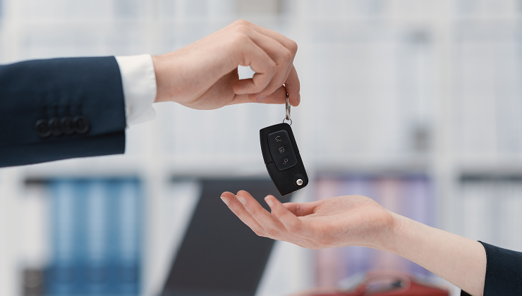 Car key being handed to a customer.