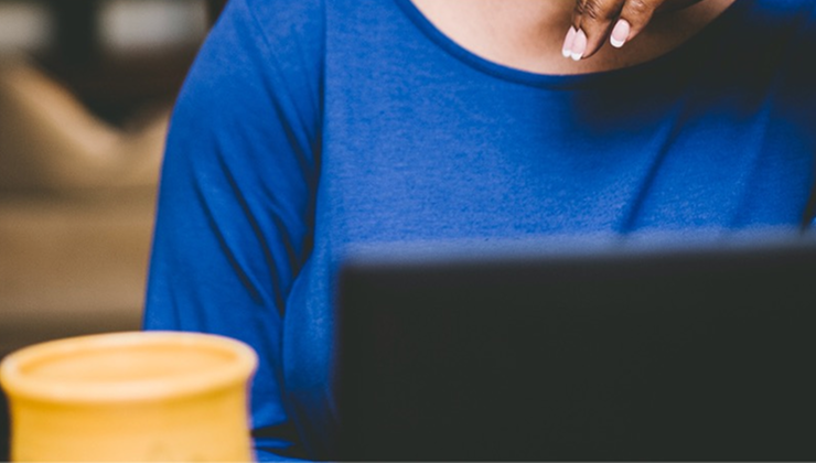 Person working on a laptop at a table.